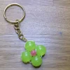 Clearance En nyckelring med grön blomma Nøgleringe & Nøgleetuier