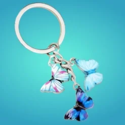 Sale Oanvänd nyckelring i metall med tre söta blåfärgade fjärilar Nøgleringe & Nøgleetuier